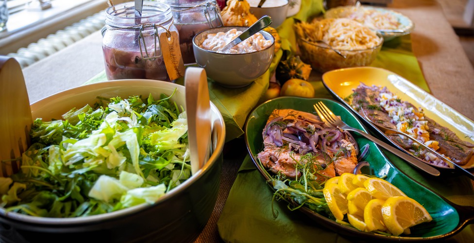 Swedish and Scandinavian smorgasbord with an assortment of cold cuts, herring, salmon, sauces, vegetables and fruits.