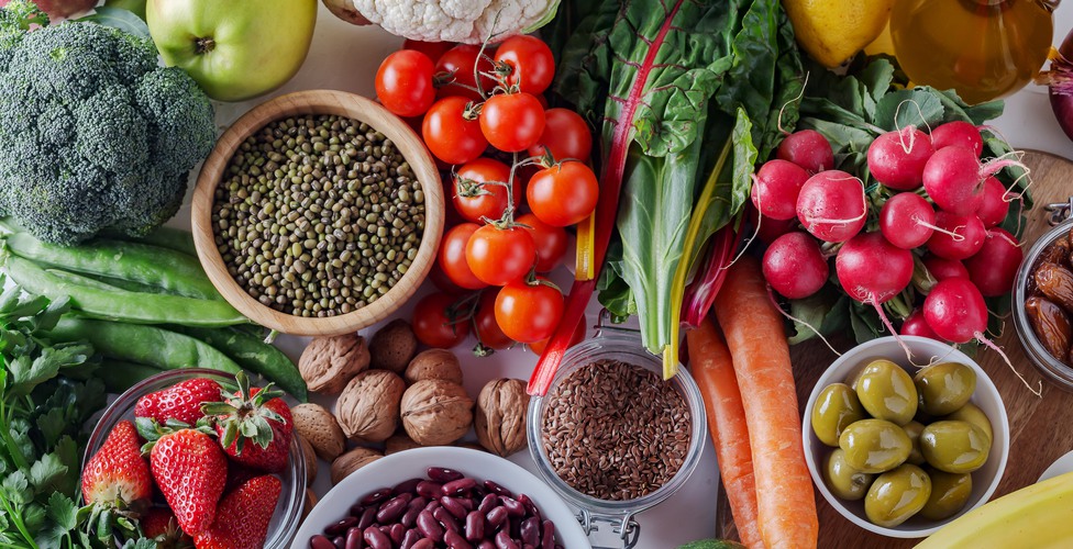 Healthy food clean eating : fruit, vegetable, seeds, superfood, cereals, leaf vegetable on white background with copy space, top view. Soft focus